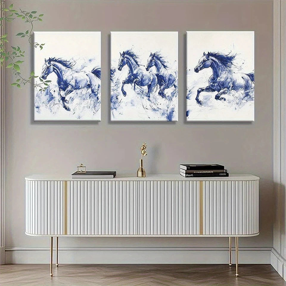 Three blue and white horse paintings above a decorative cabinet.