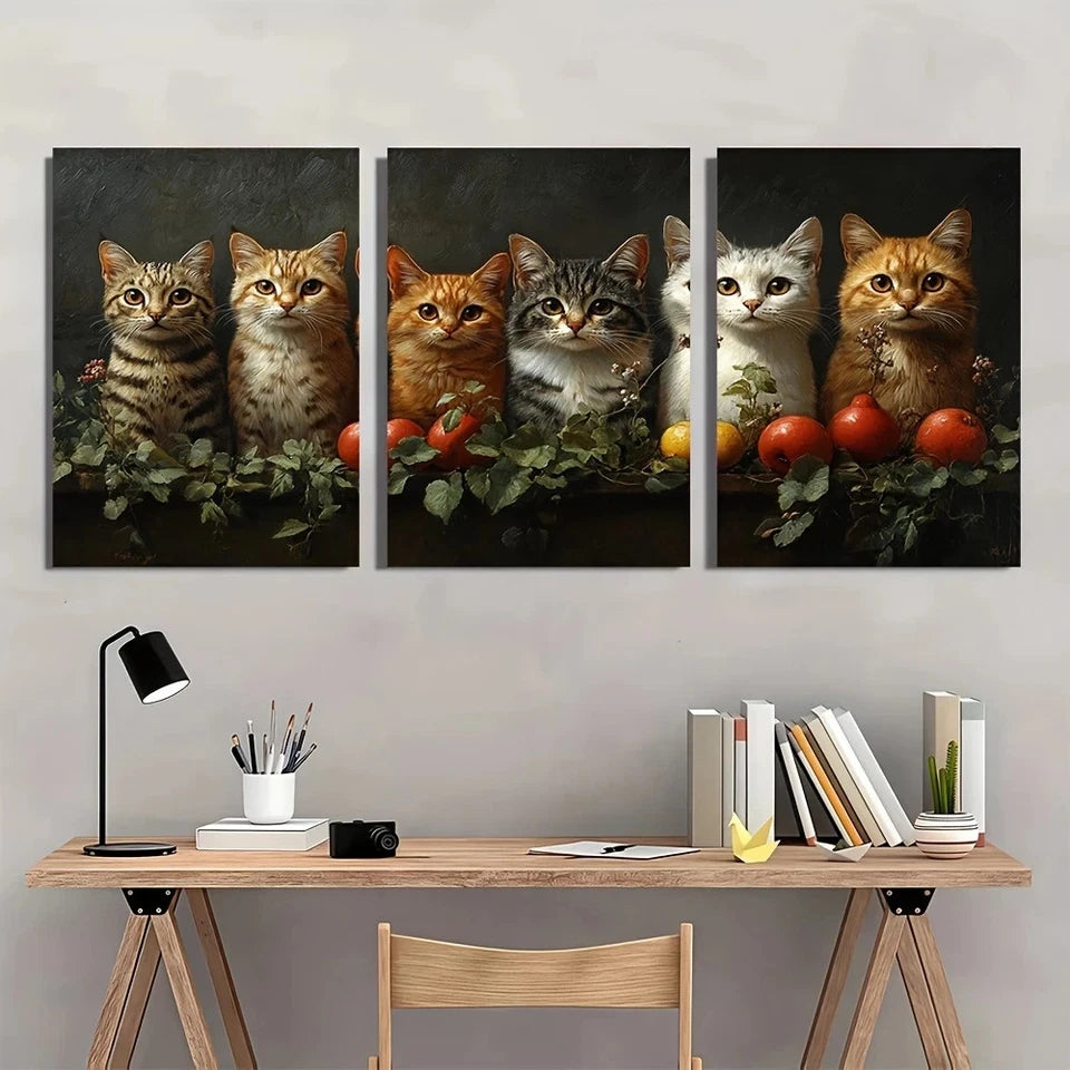 Three-panel artwork of cats with fruits on a wall above a desk.