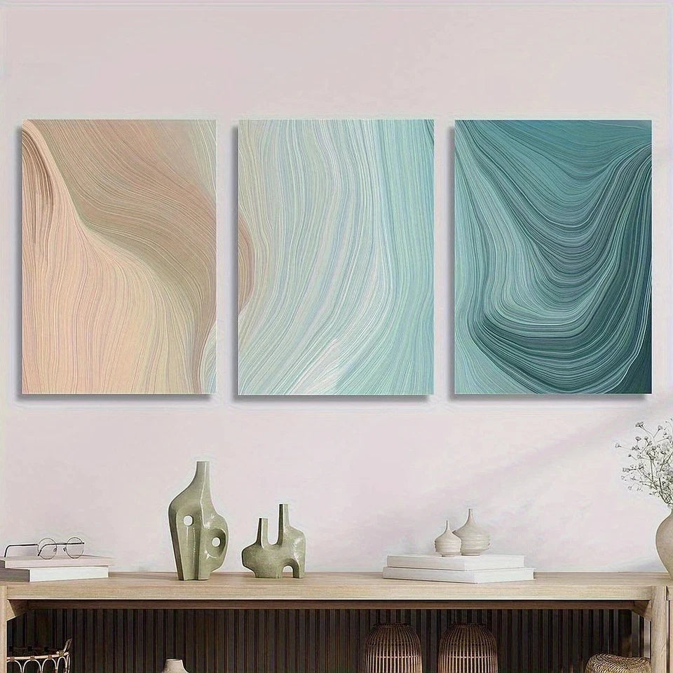 Three abstract wall art pieces on a pink wall with decorative items below.