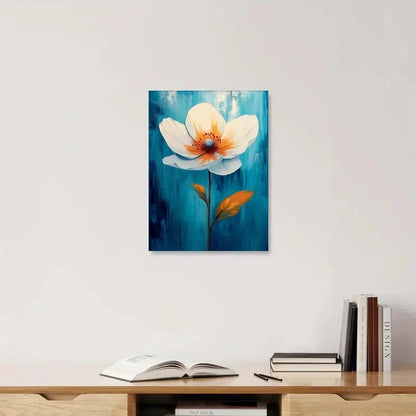 Framed painting of a flower on a wall above a wooden shelf with books and an open book.