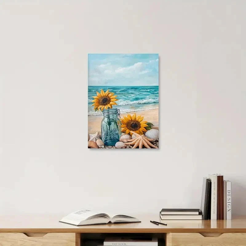 Canvas print of sunflowers and a jar on a beach with books and stationery on a desk below.