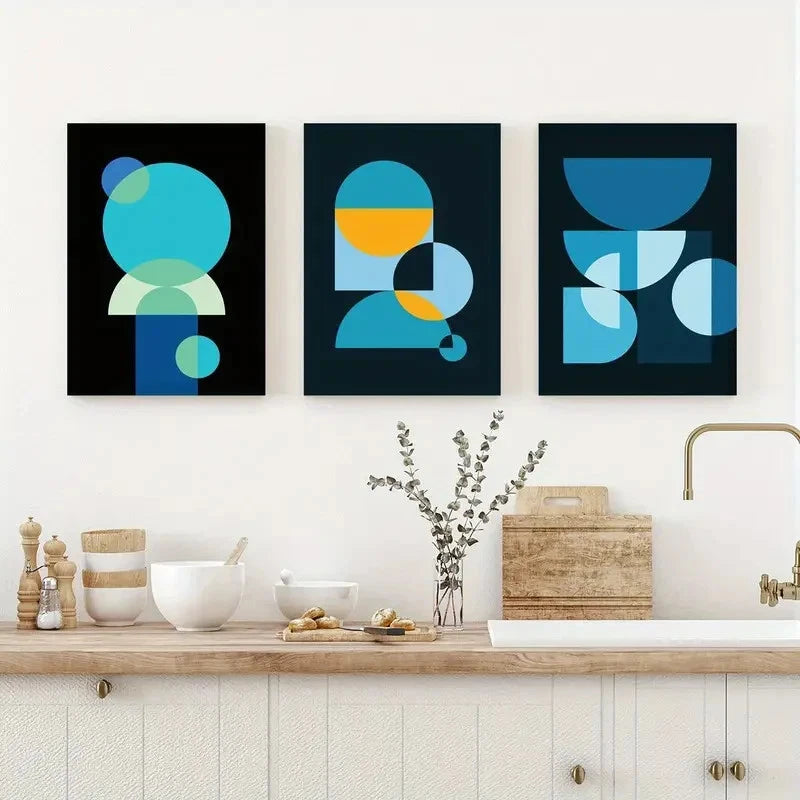 Three abstract art prints in a modern kitchen setting.
