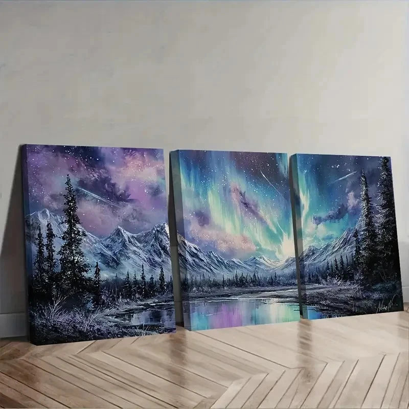 Three canvas prints of a mountain landscape with celestial elements on a wooden floor.