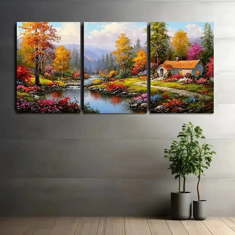 Three-panel canvas print of a colorful autumn landscape with a house, trees, and flowers on a gray wall.