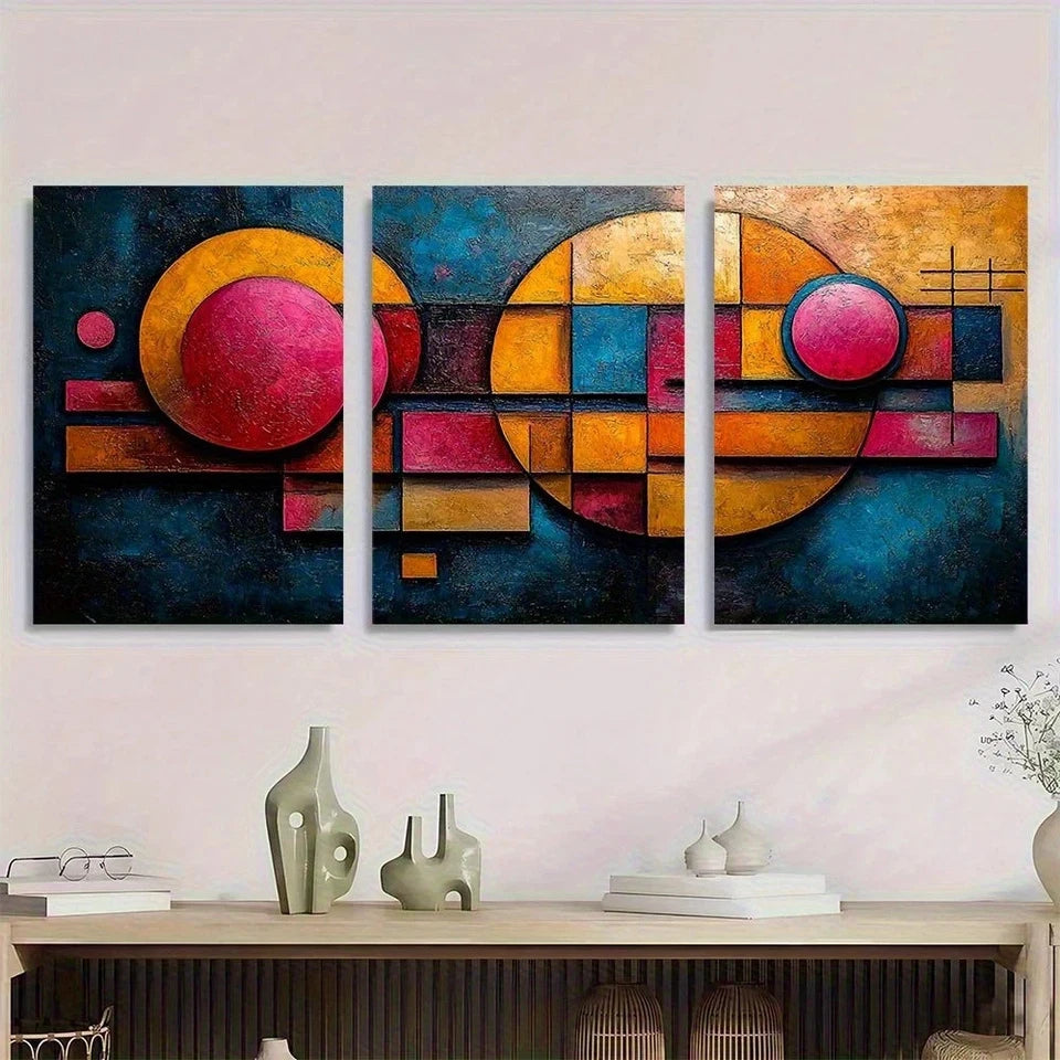 Three abstract paintings with colorful geometric designs on a wall above a wooden console table.