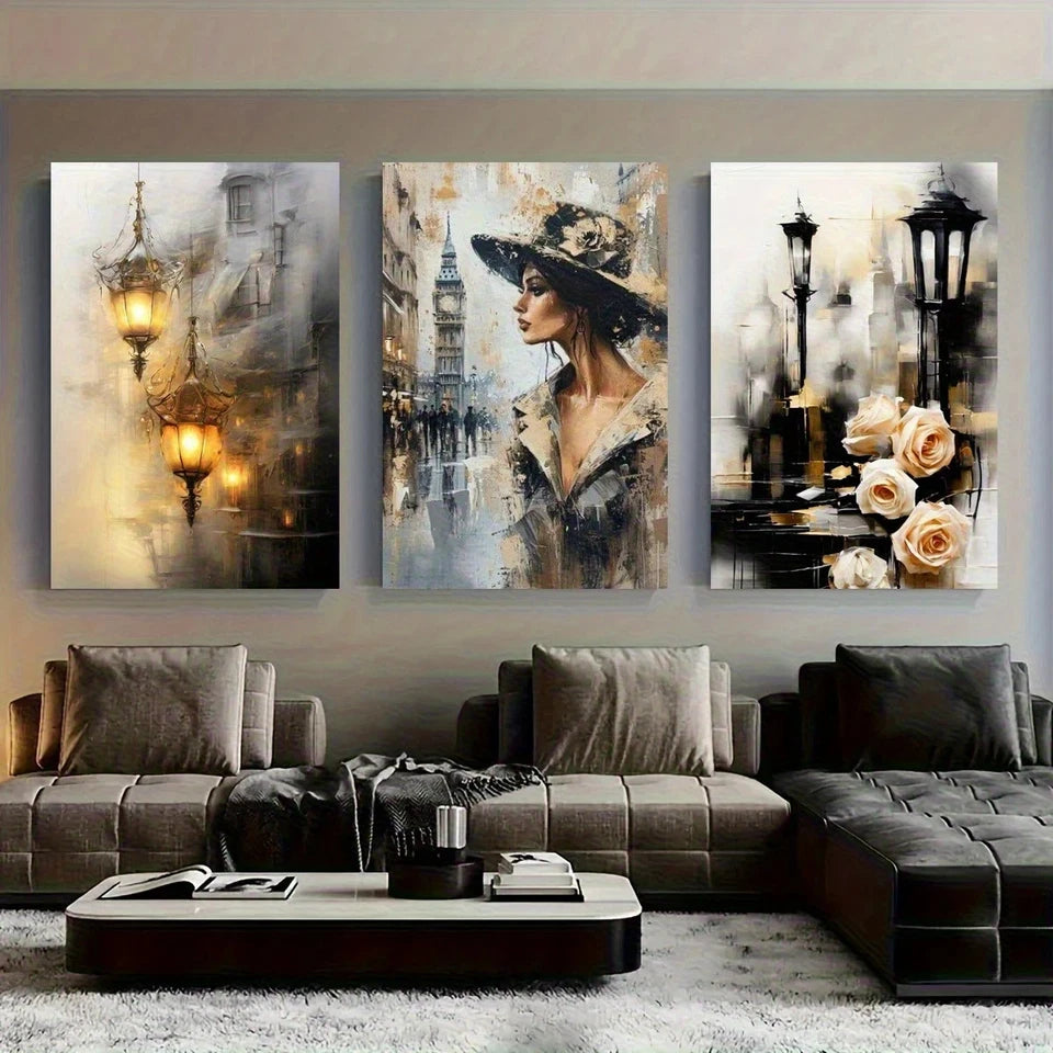 Three artistic wall paintings above a modern sofa in a living room.