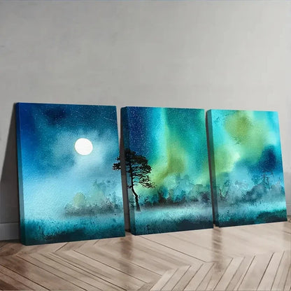 Three canvas prints depicting a night sky with a moon, tree, and aurora borealis on a wooden floor.