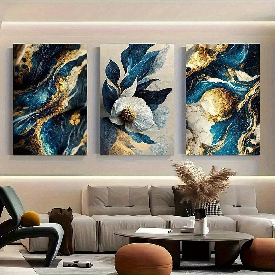 Three abstract art pieces on a wall above a sofa in a living room.