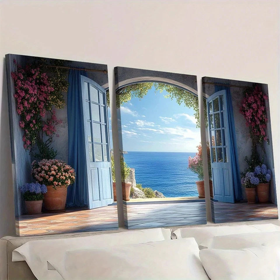 Triptych wall art of a coastal scene with open doors and flowers.
