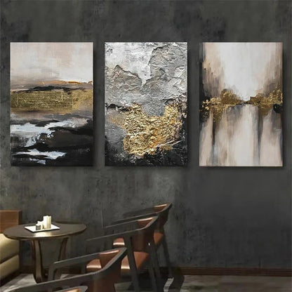 Three abstract art pieces with gold and black accents on a dark wall.