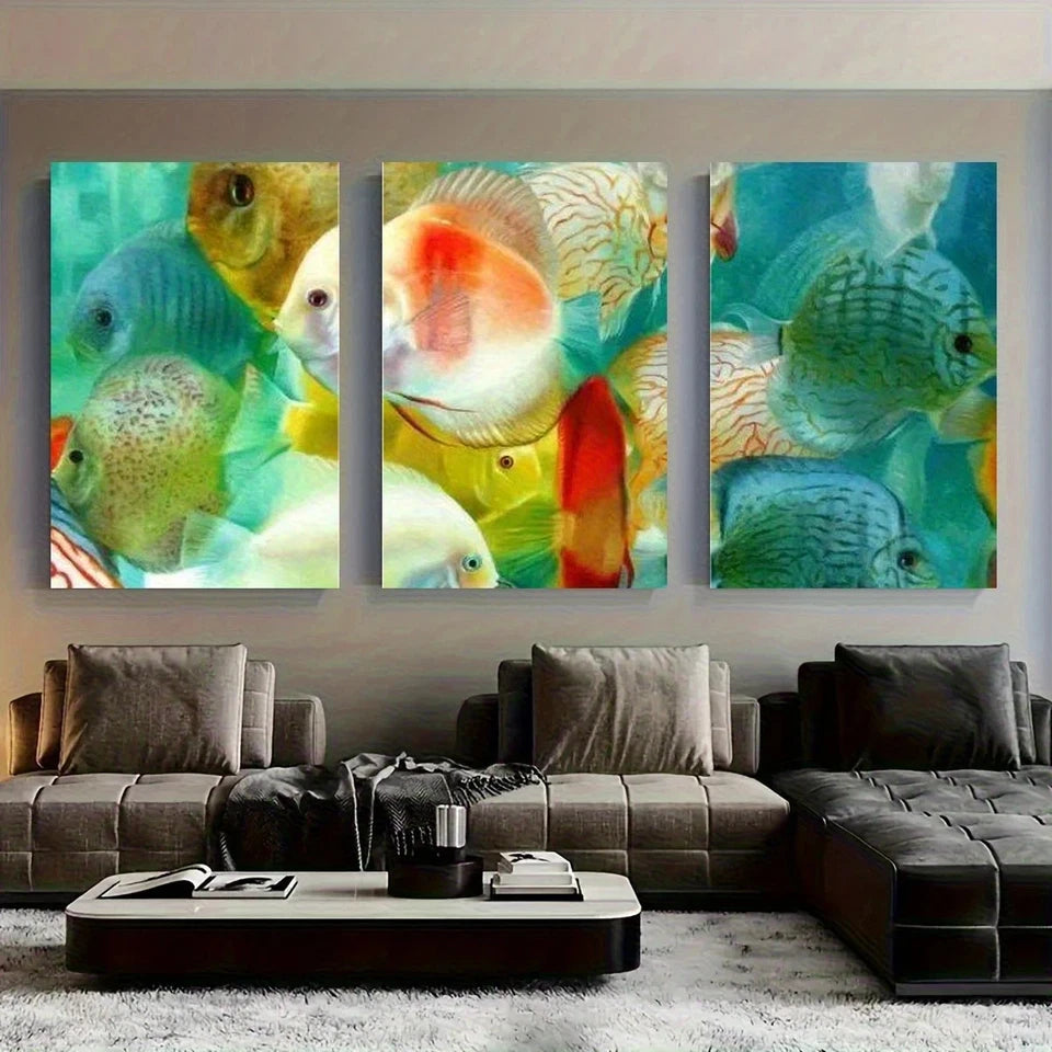 Three colorful fish paintings on a wall above a modern sofa.