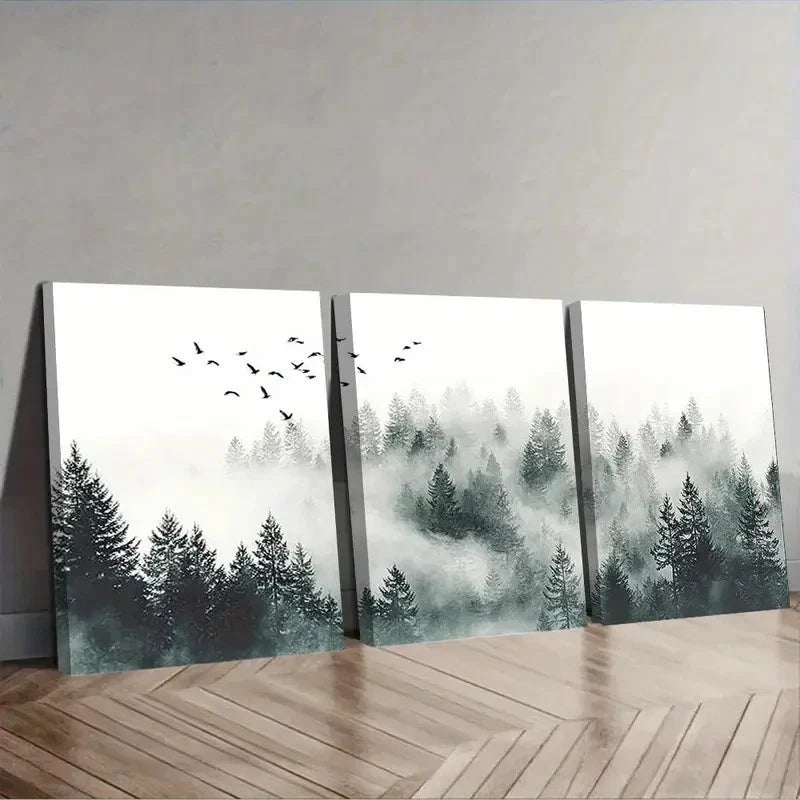 Three canvas prints of a forest scene with trees and birds on a wooden floor.