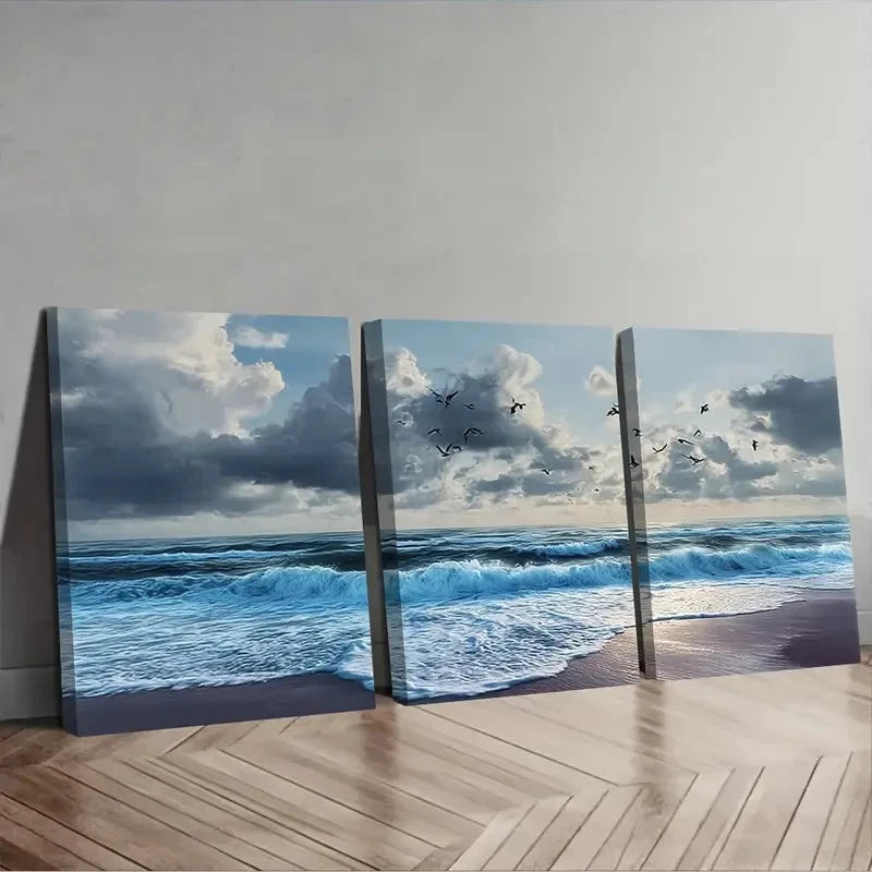 Three canvas prints of a beach scene with ocean waves and sky.
