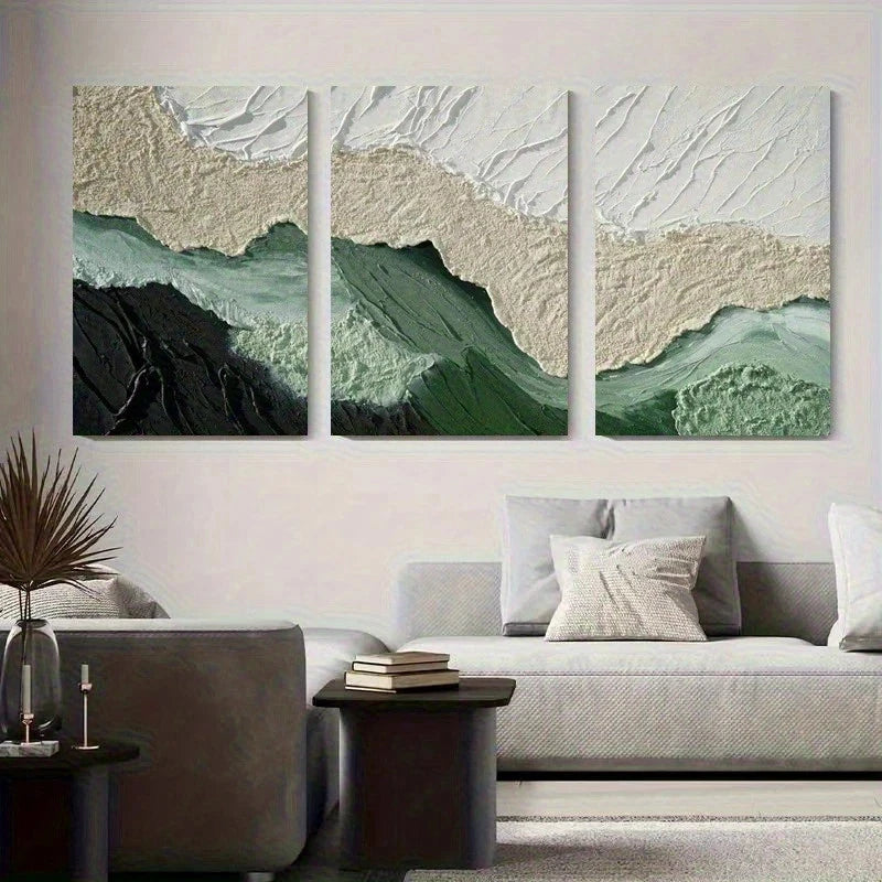 Three abstract wall art pieces in green and beige tones above a sofa in a living room.